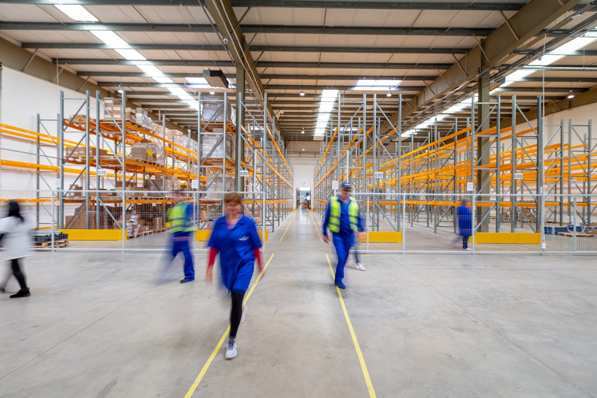 Distribution associate moving medical supply pallets in a warehouse
